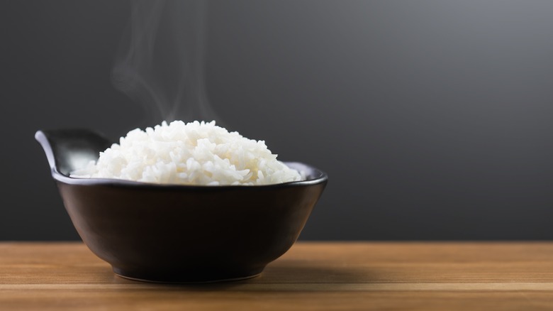 Fluffy rice in black ceramic bowl