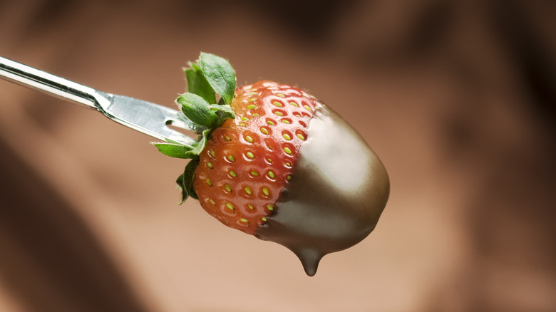 dipping strawberry in melted chocolate