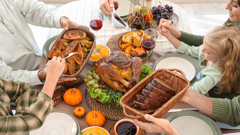 A family enjoying thanksgiving around the table