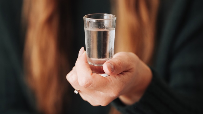 woman holding vodka shot