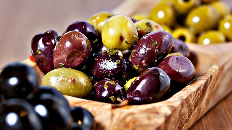 Olive varieties on wooden snack tray