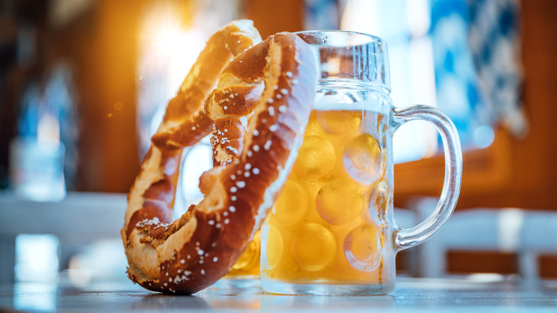 Beer and pretzel leaned together