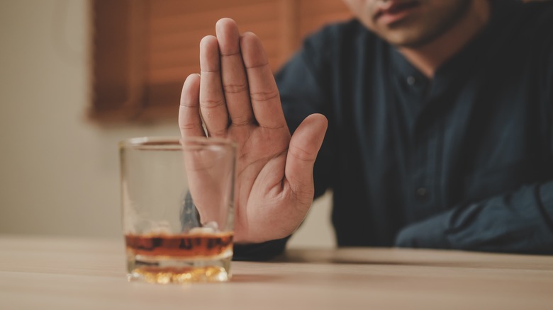 Persons hand up refusing alcohol