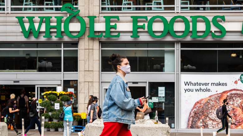 person walking in front of Whole Foods