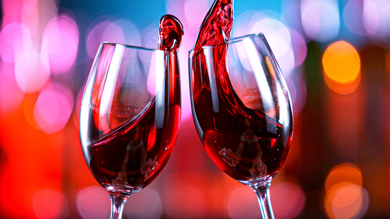 Two glasses of red wine swilling in glasses
