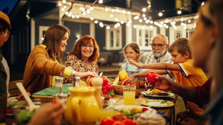 people enjoying evening meal outside