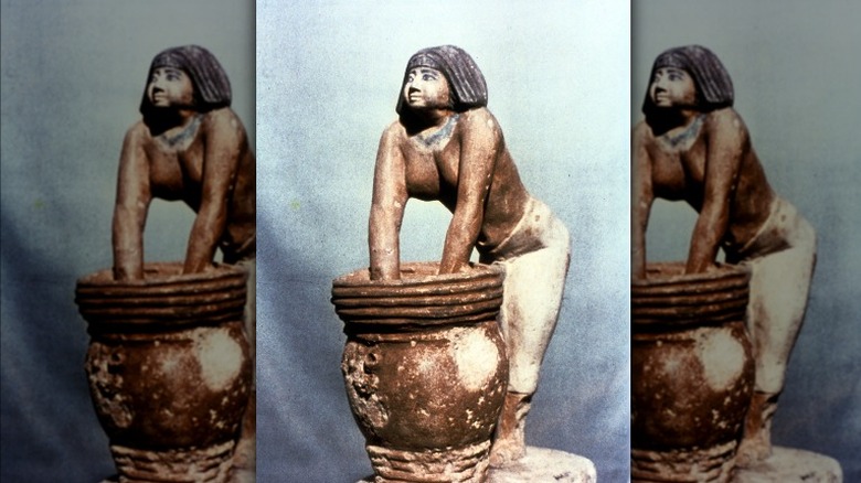 Ancient Egyptian woman brewing beer statue