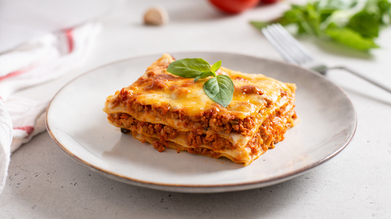 lasagna topped with sprig of basil