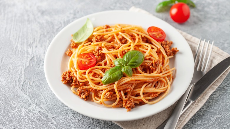 spaghetti with meat sauce on white plate