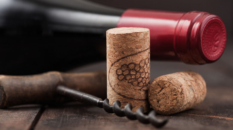 Two corks next to bottle of wine 