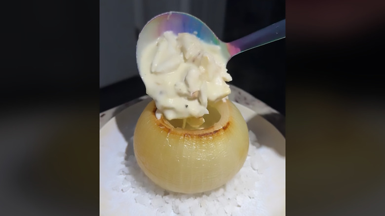 Onion bowl being filled with soup