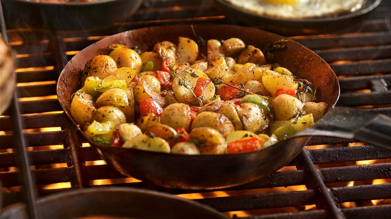 Skillet of potatoes on grill