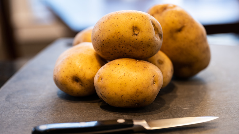 pile of yukon gold potatoes on cutting board