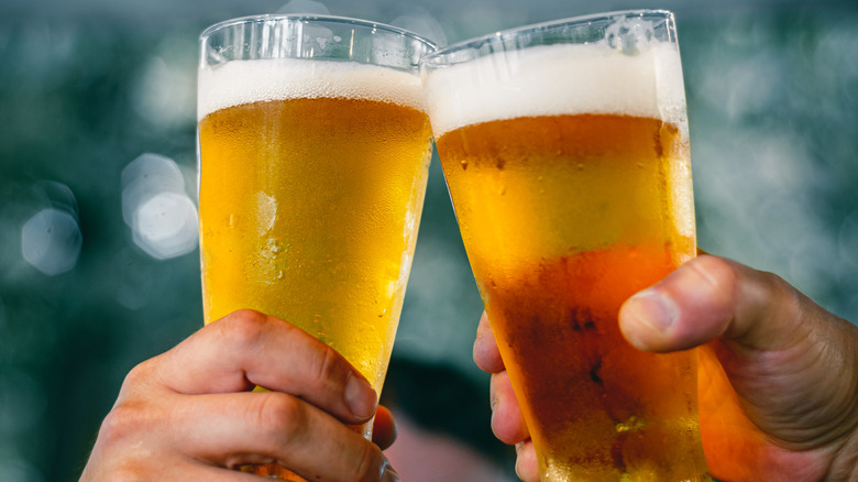 Friends toast with beer glasses