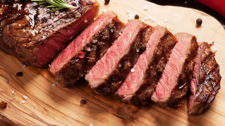 sliced steak on cutting board