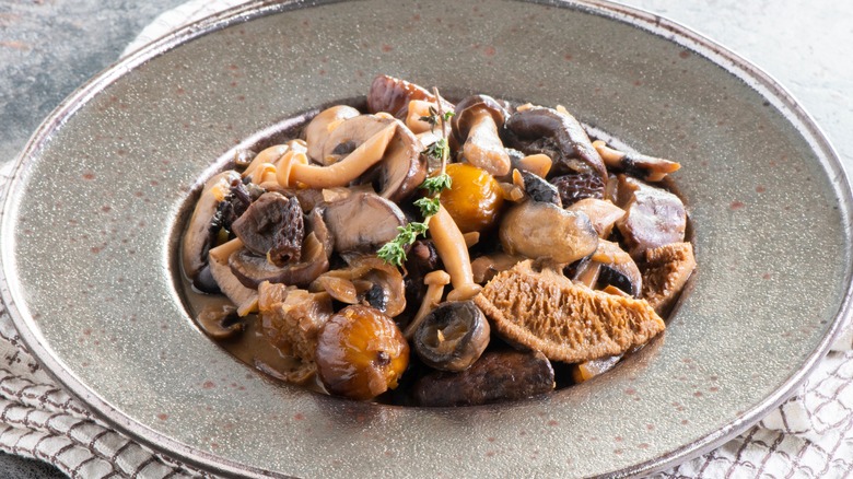 sautéed wild mushrooms in shallow plate