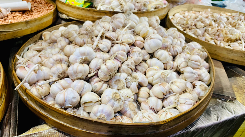 Wooden trays piled high with garlic heads