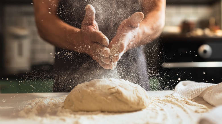 sprinkling flour on dough