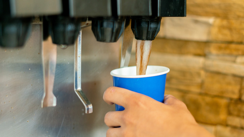 Serving soda in blue cup