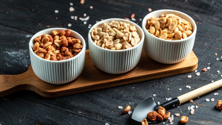 board with bowls of peanuts