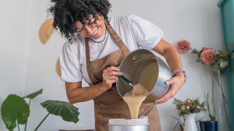 Pouring cake batter into tin