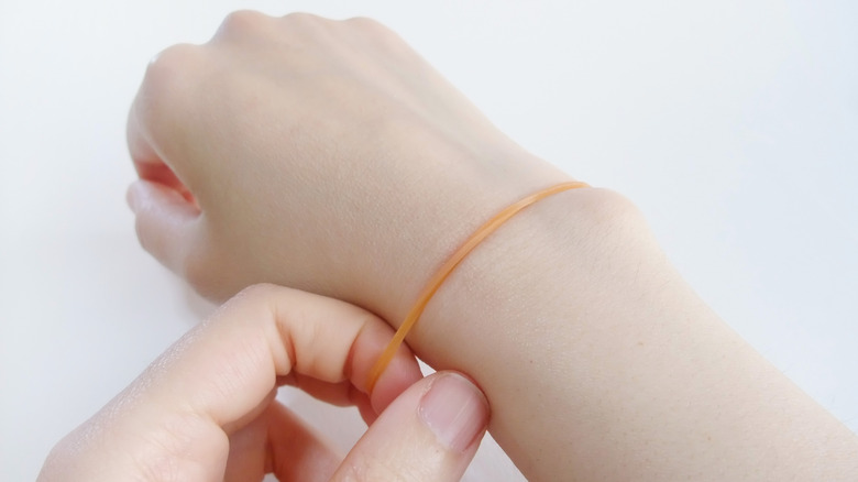 A rubber band wrapped around a wrist