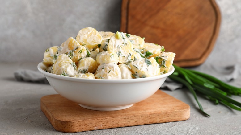 creamy potato salad on wooden board