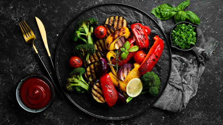 Grilled vegetables on a black plate