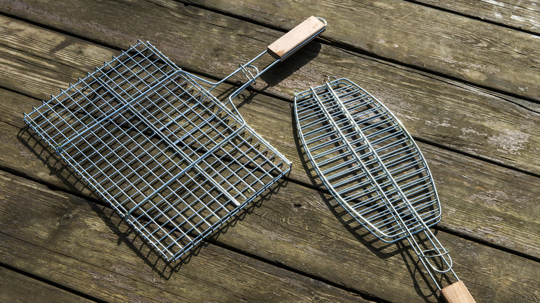 two grill baskets on wood surface