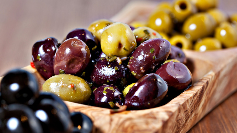 Marinated olives in wooden dish