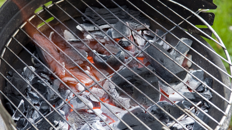 lump charcoal burning in grill