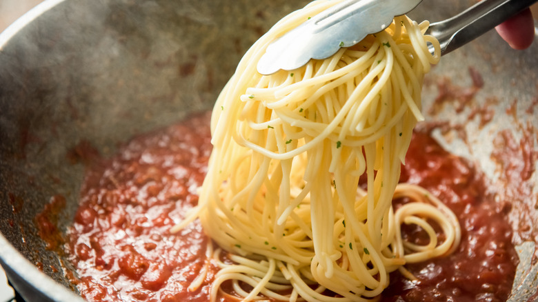 cooking spaghetti in tomato sauce