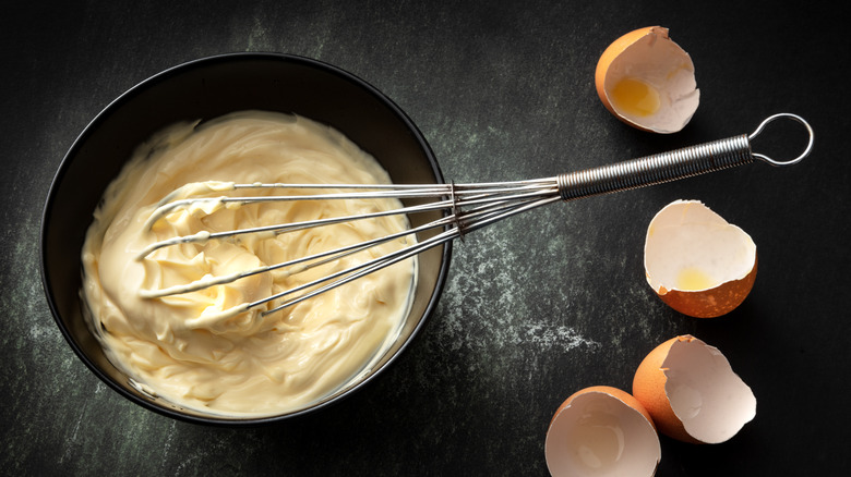 whisking mayonnaise in a bowl