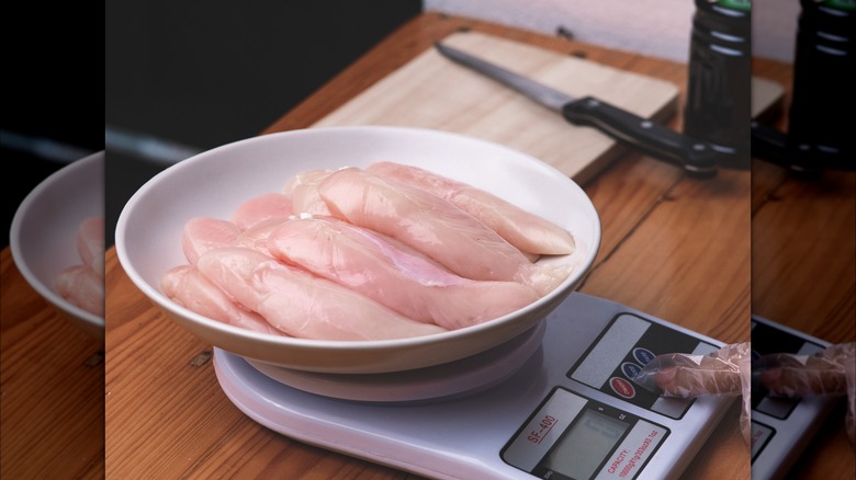 Raw chicken tenders on digital scale