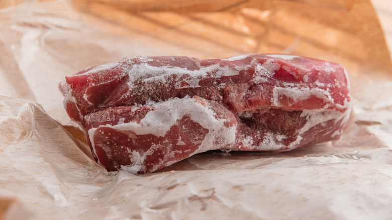 frozen steak on packing paper