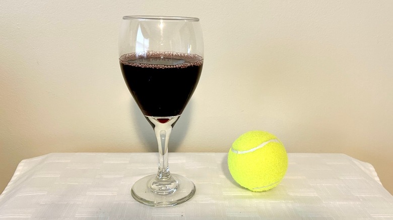 Red wine and tennis ball