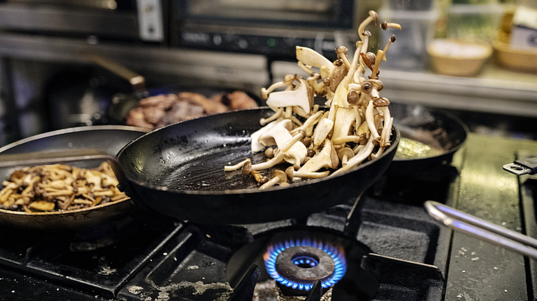 Mushrooms cooking in hot pan