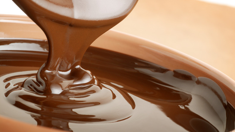 Melted chocolate dripping from spoon