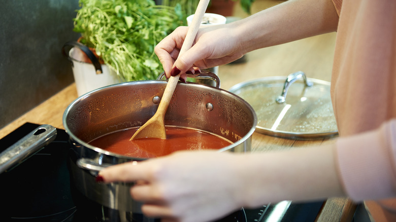 Person making pot of soup