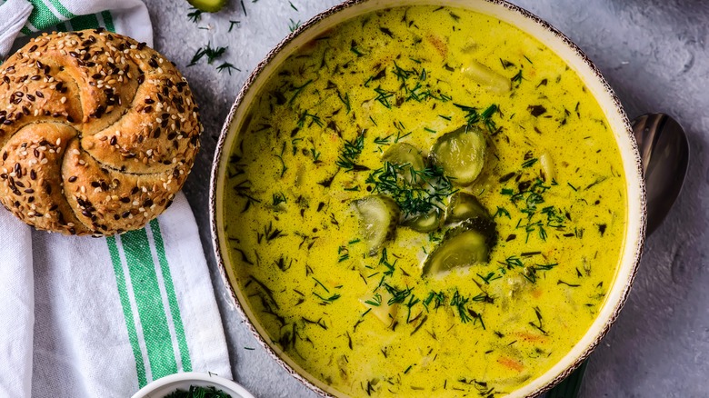 Green soup garnished with pickles