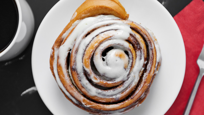 overhead shot of a giant cinnamon roll on a plate