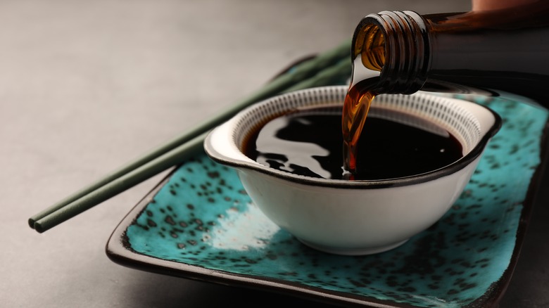 Soy sauce pouring into bowl