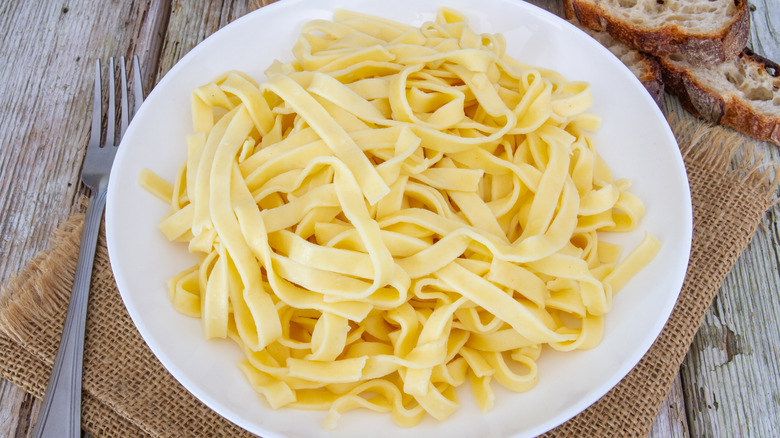 Buttered noodles on white plate