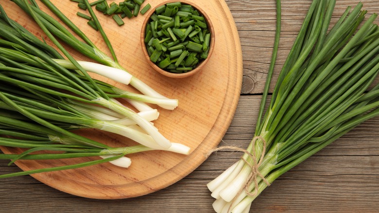 cut green onions on wooden table