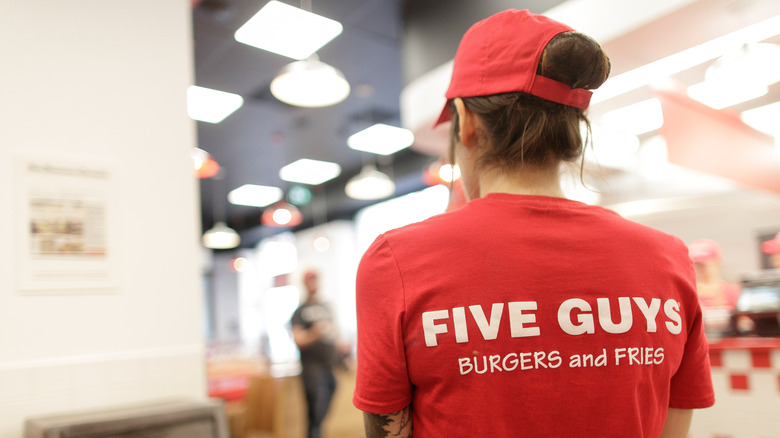 Employee wearing a Five Guys t-shirt