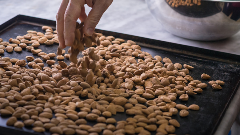 Toasting almonds on a tray