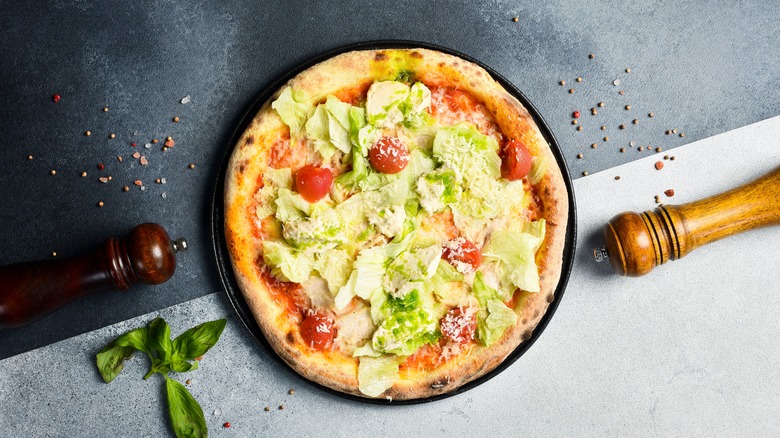 Pizza with salad on top