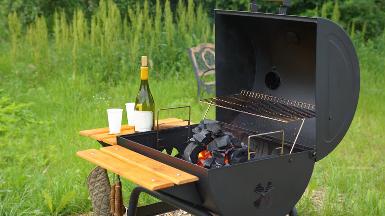 Outdoor smoker and bottle of wine