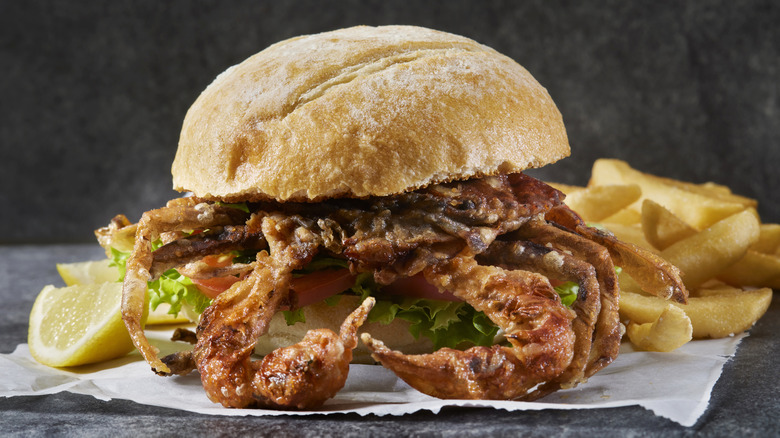 Soft-shell crab sandwich on dark background