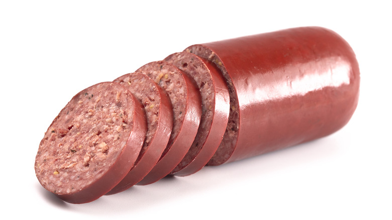 a tube of summer sausage with slices